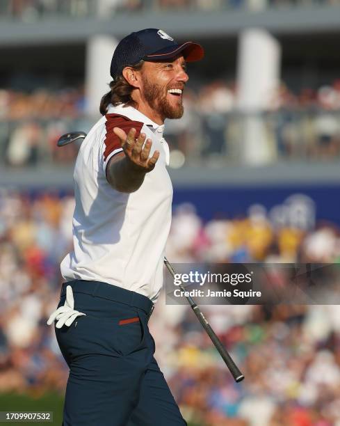 Tommy Fleetwood of Team Europe reacts after chipping in on the 16th green to win the hole during the Saturday afternoon fourball matches of the 2023...