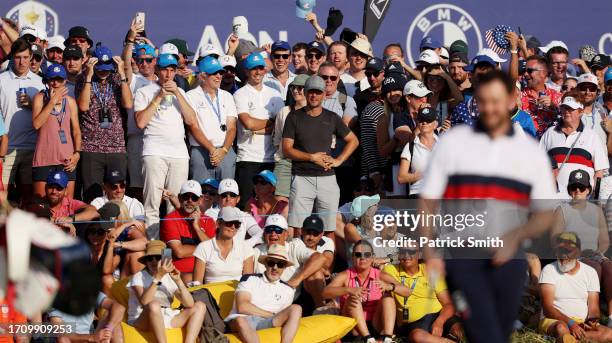 Spectators shake their hats and caps at Patrick Cantlay of Team United States on the 10th hole during the Saturday afternoon fourball matches of the...