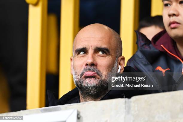 Pep Guardiola, Manager of Manchester City, reacts from the stands, serving a touchline ban suspension during the Premier League match between...