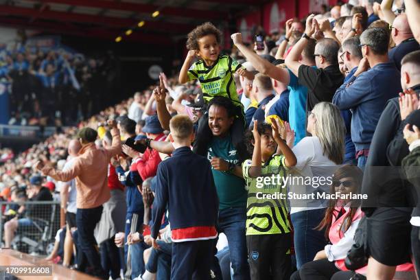 Arsenal fans celebrate during the Premier League match between AFC Bournemouth and Arsenal FC at Vitality Stadium on September 30, 2023 in...