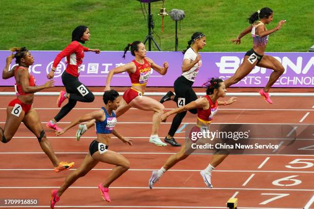 Ge Manqi of Team China crosses the finish line to win the Athletics - Women's 100m Final on day seven of the 19th Asian Games at Hangzhou Olympic...