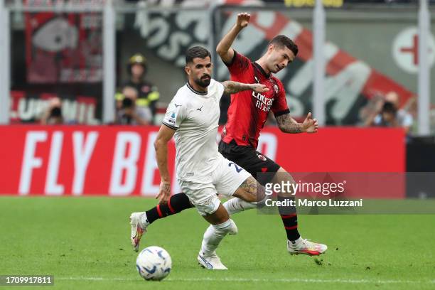 Mattia Zaccagni of Lazio is put under pressure by Christian Pulisic of AC Milan during the Serie A TIM match between AC Milan and SS Lazio at Stadio...