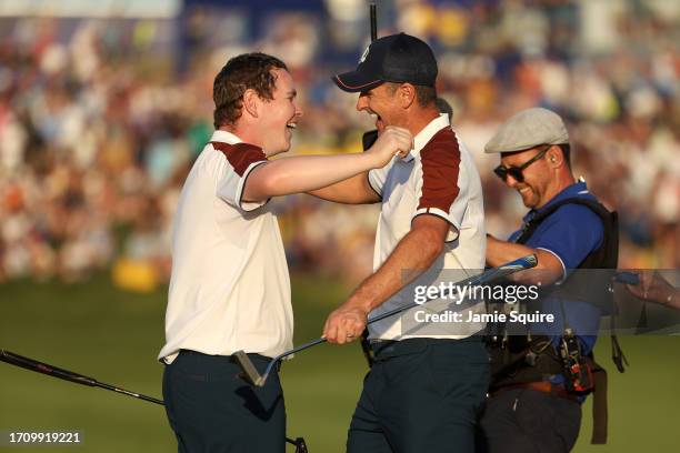 Justin Rose and Robert MacIntyre of Team Europe celebrate winning their match 3&2 during the Saturday afternoon fourball matches of the 2023 Ryder...