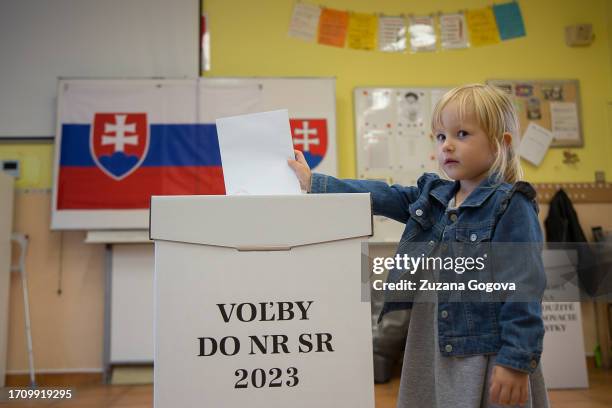 Girl prepares to post the ballot of her accompanying adult in Slovak parliamentary elections on September 30, 2023 in Bratislava, Slovakia. The...