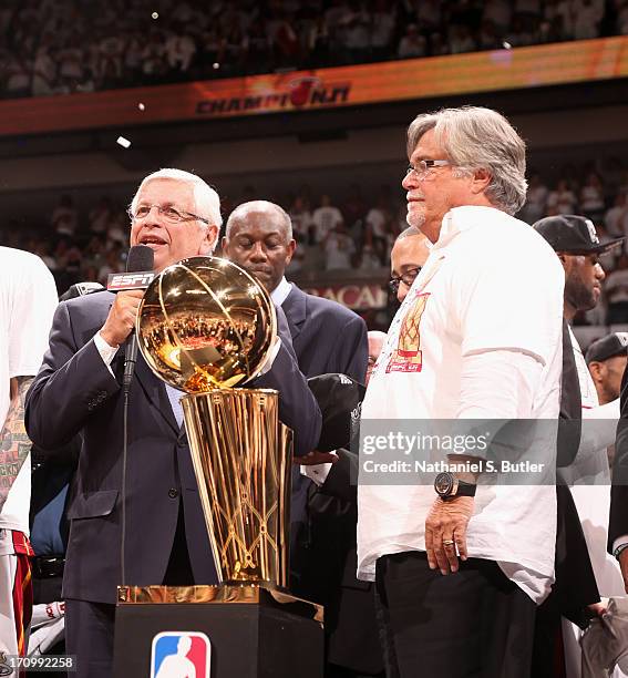 Commissioner of the National Basketball Association David Stern presents the owner of the Miami Heat Micky Arison with the Larry O'Brien Championship...