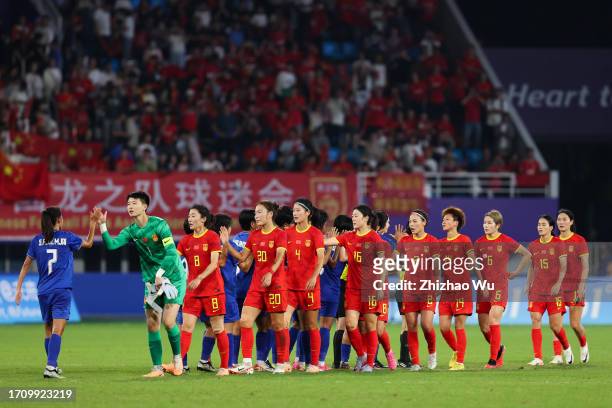 Players of China shake hand with Players of Thailand during the 19th Asian Games Women's Quarterfinal match between China and Thailand at Linping...