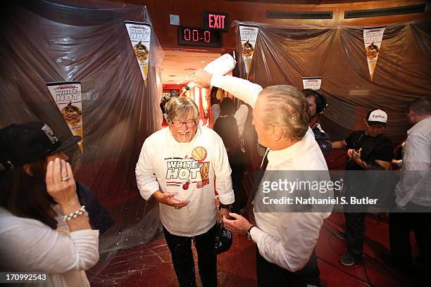 President of the Miami Heat Pat Riley pours champagne on the owner of the Miami Heat Micky Arison as they celebrate defeating the San Antonio Spurs...