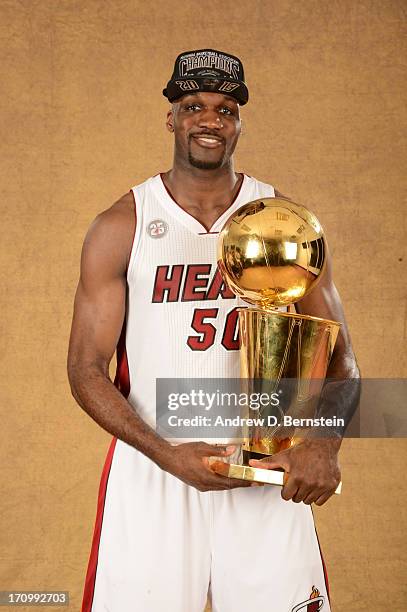 Joel Anthony of the Miami Heat poses for a portrait with the Larry O'Brien Trophy after defeating the San Antonio Spurs in Game Seven of the 2013 NBA...