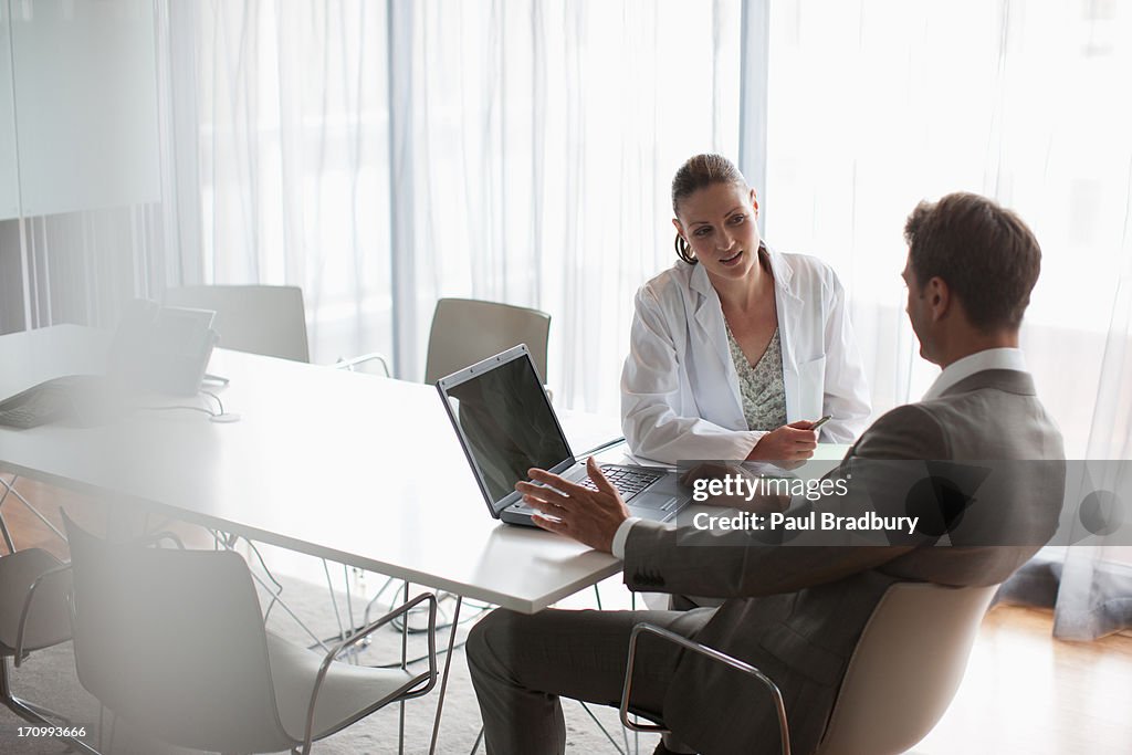 Businessman working with scientist in conference room