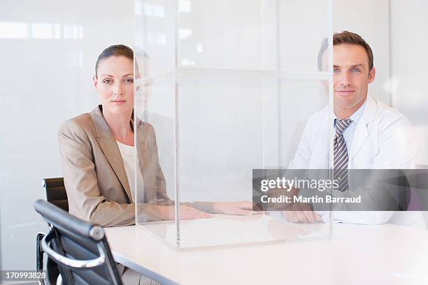 business people at conference table with transparent cube - overhemd en stropdas stockfoto's en -beelden