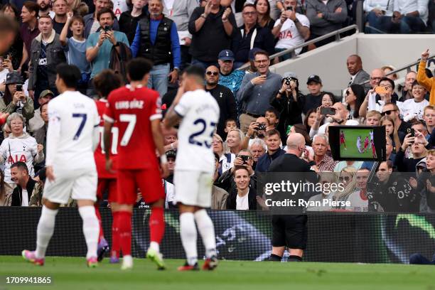 Referee, Simon Hooper watches the Video Assistant Referee before awarding a red card to Curtis Jones of Liverpool during the Premier League match...