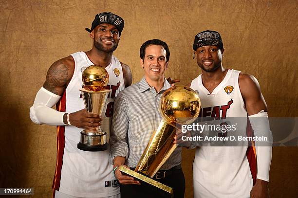 LeBron James, Head Coach Erik Spoelstra and Dwyane Wade of the Miami Heat poses for a portrait with the Larry O'Brien Trophy after defeating the San...