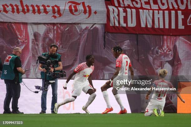 Castello Lukeba of RB Leipzig celebrates with teammates after scoring the team's second goal during the Bundesliga match between RB Leipzig and FC...