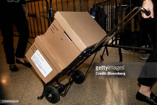 Boxes are wheeled into a courtroom at New York State Supreme Court in New York, US, on Friday, Oct. 6, 2023. Donald Trump is facing off against New...