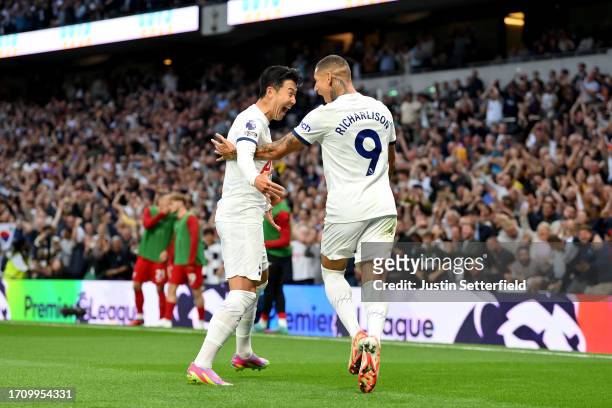 Heung-Min Son of Tottenham Hotspur celebrates with teammate Richarlison after scoring the team's first goal during the Premier League match between...