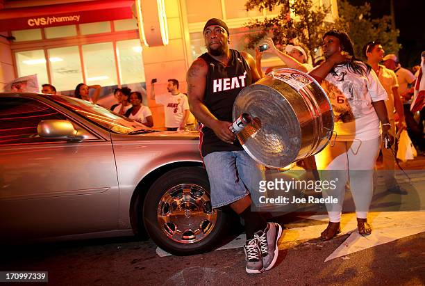 Fans celebrate in the streets after the Miami Heat won the NBA title against the San Antonio Spurs on June 20, 2013 in Miami, Florida. The Heat have...