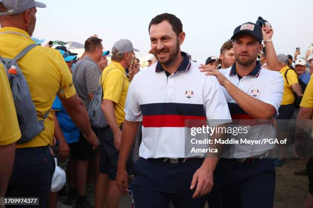 Patrick Cantlay and Wyndham Clark of Team United States leave the 18th green following the Saturday afternoon fourball matches of the 2023 Ryder Cup...