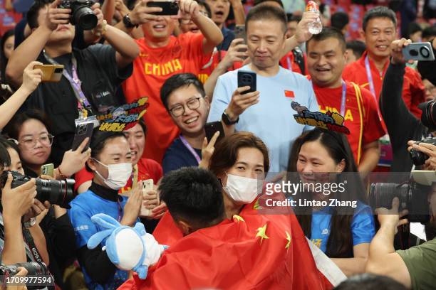 Xie Zhenye of China celebrates with his wife afterwinning the men's 100m final athletics event during day 7 of the of the 19th Asian Games at...