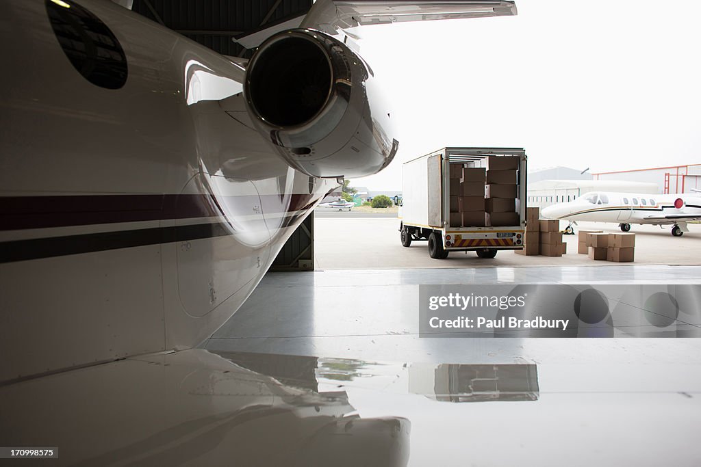 Airplane and truck being loaded with boxes