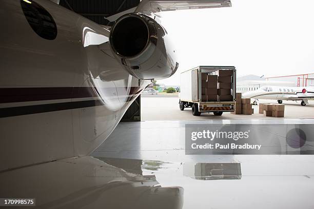 airplane and truck being loaded with boxes - mail plane stock pictures, royalty-free photos & images