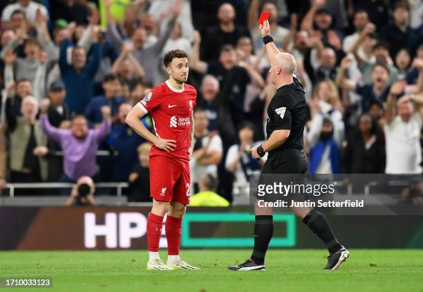 Referee, Simon Hooper shows a red card to Diogo Jota of Liverpool during the Premier League match between Tottenham Hotspur and Liverpool FC at...