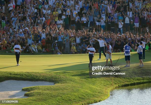 Justin Rose of England and The European Team celebrates on the 16th green after holing a birdie putt to win his match with Robert MacIntyre against...