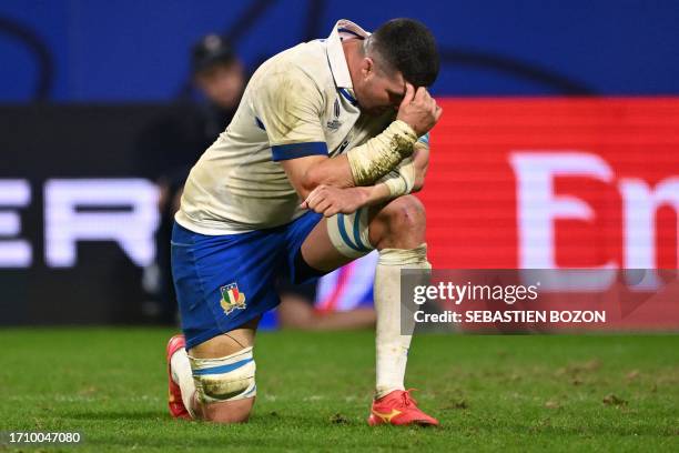 Italy's blindside flanker Sebastian Negri kneels down in emotion at the end of the France 2023 Rugby World Cup Pool A match between France and Italy...