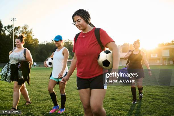 group of female players walking on field for soccer practice - championship day three stock pictures, royalty-free photos & images