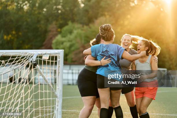 female soccer players cheering and huddling while team practice on field - goalie stock pictures, royalty-free photos & images