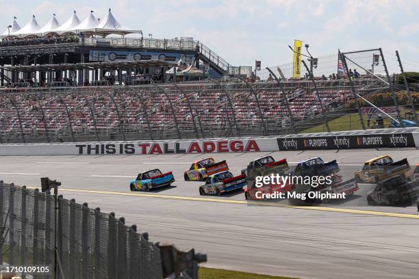 Carson Hocevar, driver of the Worldwide Express Chevrolet, and Parker Kligerman, driver of the Tide Chevrolet, lead the field during the NASCAR...