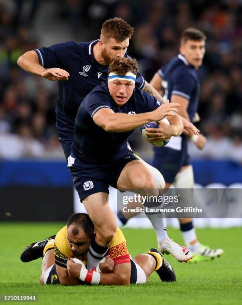 Hamish Watson of Scotland is tackled by Alexandru Savin of Romania during the Rugby World Cup France 2023 match between Scotland and Romania at Stade...