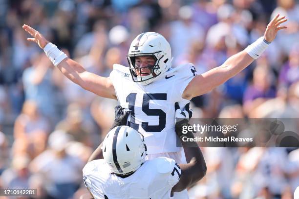 Drew Allar of the Penn State Nittany Lions celebrates with Olumuyiwa Fashanu after a rushing touchdown against the Northwestern Wildcats during the...