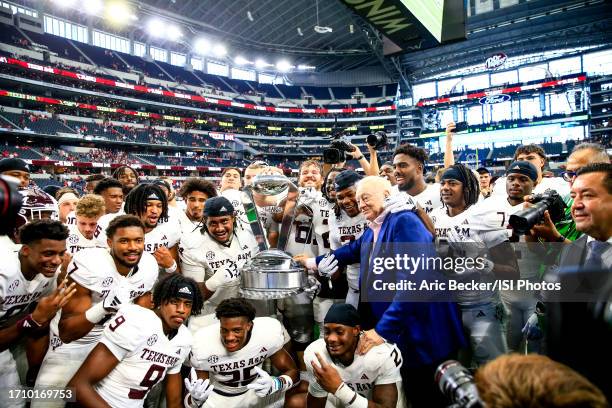 Texas A&M Aggies celebrate with Dallas Cowboys owner Jerry Jones during a game between the University of Arkansas Razorbacks and Texas A&M Aggies at...