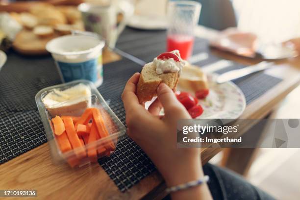 closeup of teenage girl having breakfast - dip girls stock pictures, royalty-free photos & images
