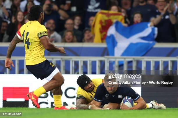 Chris Harris of Scotland scores the team's seventh try whilst under pressure from Jason Tomane of Romania during the Rugby World Cup France 2023...