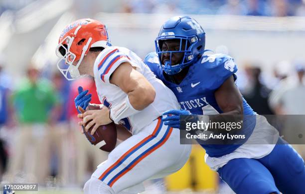 Graham Mertz of the Florida Gators is pressured by D'Eryk Jackson of the Kentucky Wildcats at Kroger Field on September 30, 2023 in Lexington,...