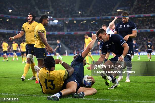 Chris Harris of Scotland celebrates scoring the team's seventh try with teammate Cameron Redpath during the Rugby World Cup France 2023 match between...