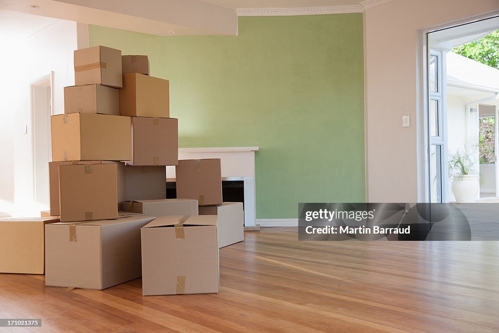 Boxes stacked in living room of new house