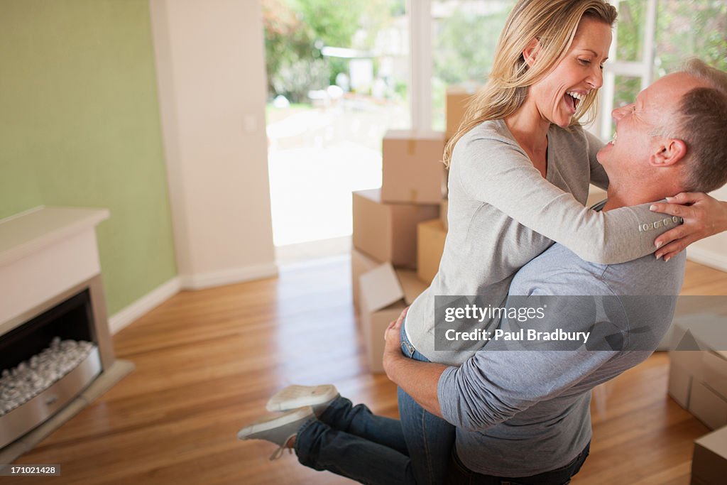 Couple hugging in new house