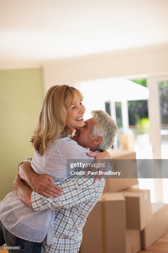 Couple hugging in new house