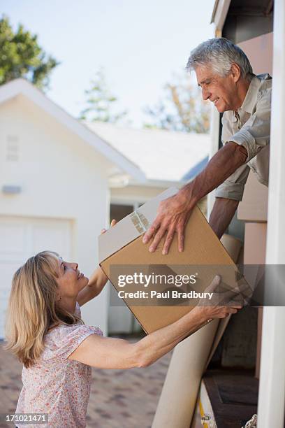 couple unloading boxes from moving van - old moving van stock pictures, royalty-free photos & images