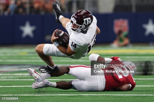 Quarterback Max Johnson of the Texas A&M Aggies is tackled by defensive back Dwight McGlothern of the Arkansas Razorbacks in the second quarter of...