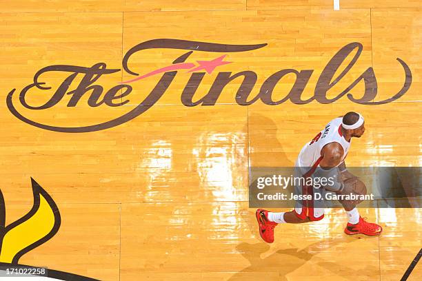 LeBron James of the Miami Heat controls the ball near "The Finals" logo while playing the San Antonio Spurs during Game Seven of the 2013 NBA Finals...