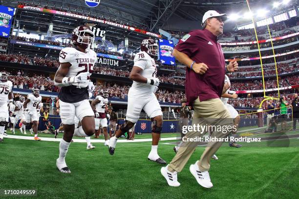 Head coach Jimbo Fisher of the Texas A&M Aggies runs onto the field with the team before the game against the Arkansas Razorbacks in the Southwest...