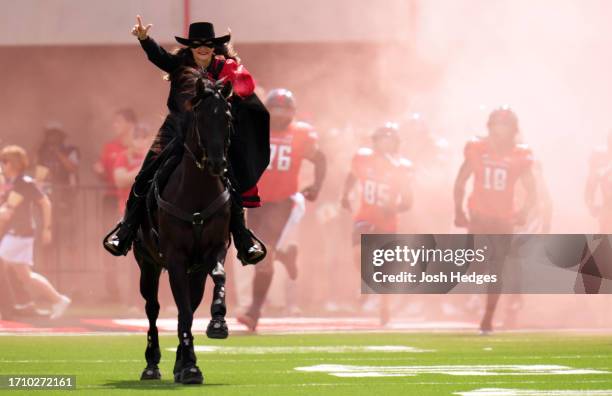 The Masked Rider and Centennial Champion lead the Texas Tech Red Raiders onto the field prior to a game against the Houston Cougars at Jones AT&T...