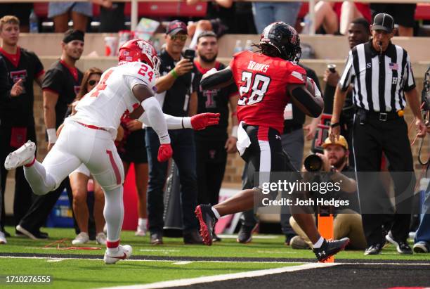 Tahj Brooks of the Texas Tech Red Raiders rushes for a touchdown during the first quarter against the Houston Cougars at Jones AT&T Stadium on...