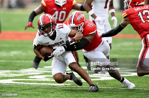 Jaylin Lucas of the Indiana Hoosiers is tackled in the first quarter by Donnell Brown of the Maryland Terrapins at SECU Stadium on September 30, 2023...