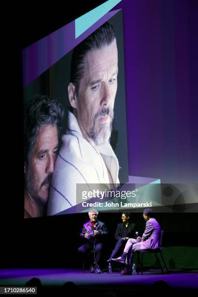 Pedro Almodóvar speaks as an interpreter and Dennis Lim listen at the "Strange Way Of Life" screening during the 61st New York Film Festival at Alice...