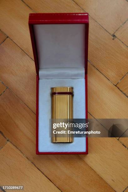 high angle view of a gold lighter in box. - premium lighter stock pictures, royalty-free photos & images