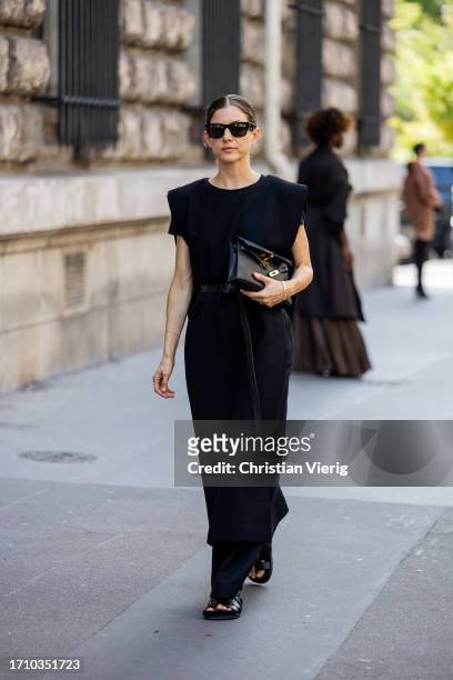 Guest wears black dress, bag outside Hermes during the Womenswear Spring/Summer 2024 as part of Paris Fashion Week on September 30, 2023 in Paris,...